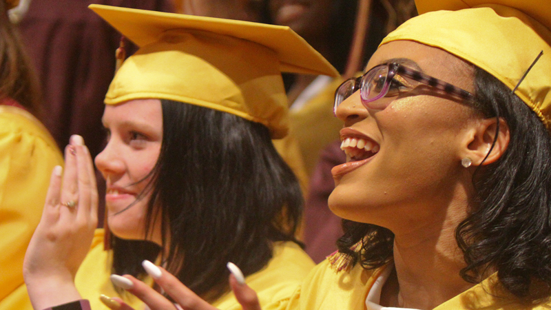 Liberty High School graduates Kayla Baker, left, and Mya Atwood applaud during the Thursday evening commencement at Stambaugh Auditorium in Youngstown. There were 88 graduates in the class of 2019.