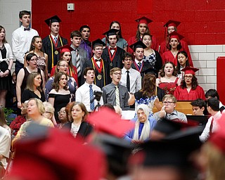 The Canfield High School choir sing "Until We Meet Again" by Kirby Shaw during the Canfield High School commencement ceremony in Canfield High School on Friday evening. EMILY MATTHEWS | THE VINDICATOR