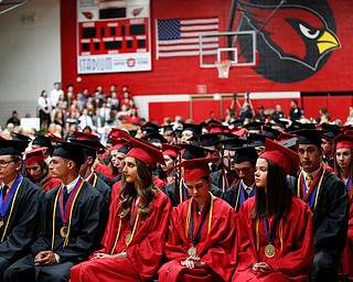 Canfield seniors wait to graduate during the Canfield High School commencement ceremony in Canfield High School on Friday evening. EMILY MATTHEWS | THE VINDICATOR