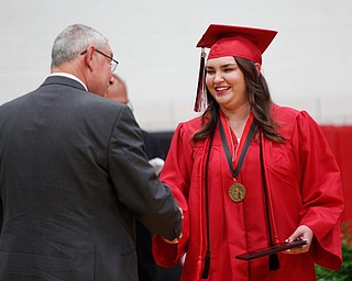 Megan Burkett receives her diploma during the Canfield High School commencement ceremony in Canfield High School on Friday evening. EMILY MATTHEWS | THE VINDICATOR