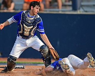 HUDSON, OHIO - MAY 31, 2019: Gilmour Academy's Nick Christopher tags out Poland's Alex Barth at home plate in the fourth inning of Friday nights OHSAA Division II Regional Semi-Final game at Hudson High School. Gilmour Academy won 11-0. DAVID DERMER | THE VINDICATOR