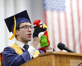 Alex Giovannone uses hand puppets in his valedictorian speech during the Austintown Fitch commencement ceremony in the school's gymnasium Saturday morning. EMILY MATTHEWS | THE VINDICATOR