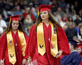 Lainie Simons, right, and Alexcia Soto walk up with the last group of valedictorians to give their address during the Austintown Fitch commencement ceremony in the school's gymnasium Saturday morning. EMILY MATTHEWS | THE VINDICATOR