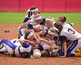 AKRON, OHIO - JUNE 1, 2019: Members of the Champion softball team dog pile on the field in celebration after defeating Cardington-Lincoln 5-0 to win the Division III State Softball Championship, Saturday morning at Firestone Stadium. DAVID DERMER | THE VINDICATOR