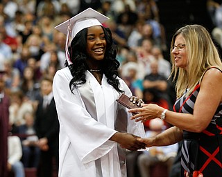 Teryn Thomas receives her diploma from Boardman Board of Education Vice President Victoria Davis during Boardman's commencement ceremony in the school's gym on Sunday afternoon. EMILY MATTHEWS | THE VINDICATOR