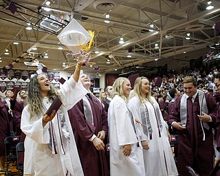 Alicia Saxton, left, throws her cap with her classmates at the end of Boardman's commencement ceremony in the school's gym on Sunday afternoon. EMILY MATTHEWS | THE VINDICATOR