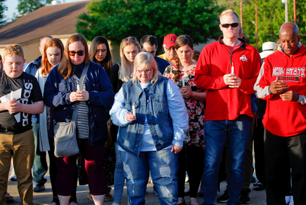 People who are gathered for a vigil to honor Brad and Jacob Crist, who died in a house fire in Niles last week, take a moment of silence at the Niles Safety-Service Complex on Sunday evening. EMILY MATTHEWS | THE VINDICATOR