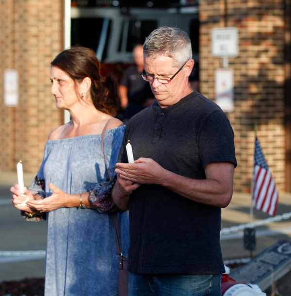 Mary Jo and Leonard Blount, cousins of Brad and Jacob Crist, hold candles in honor of Brad and Jacob, who died in a house fire in Niles last week, during a vigil for them at the Niles Safety-Service Complex on Sunday evening. EMILY MATTHEWS | THE VINDICATOR