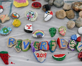 Painted rocks adorn a table at Riverfest on Sunday afternoon. The table was covered in rocks for fest-goers to paint on. EMILY MATTHEWS | THE VINDICATOR
