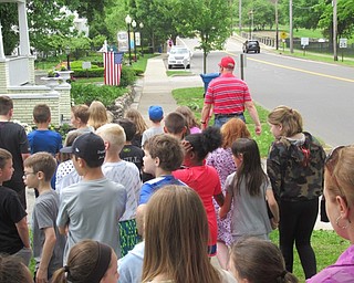 Neighbors | Jessica Harker.Jim Bartos, of the Poland Historical Society, lead a group of McKinley Elementary Students on a tour of the historical high points of Poland May 20.