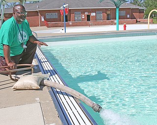 The city’s Northside Pool opens for the season Wednesday. Prep work and pool filling took place Monday under the scrutiny of pool manager Kevin Tarpley.