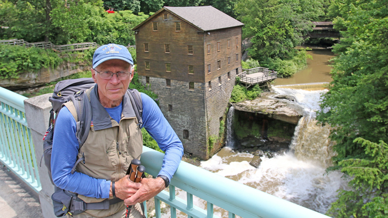 Air Force veteran William Shuttleworth has completed 600 miles of a 3,400-mile cross-country walk from Massachusetts to California to raise money for disabled American veterans and the needs of veterans in general. He posed Tuesday in front of historic Lanterman’s Mill in Mill Creek Park in Youngstown. 
