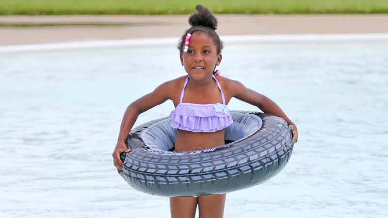 Euriana Fields, 5, enjoys playing with her inner tube in the Northside Pool on its opening day Wednesday. Pool hours are 1 to 8 p.m. Monday through Saturday.