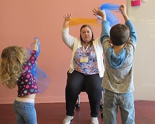 Neighbors | Jessica Harker.Children used scarves to dance along with librarian Amelia Dale as she sang songs about the rain on April 24.