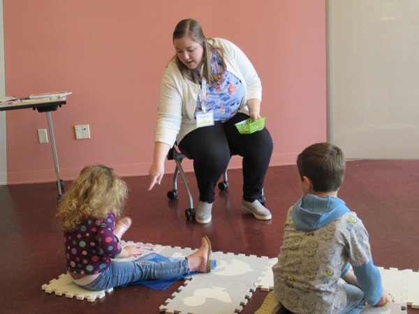 Neighbors | Jessica Harker.Librarian Amelia Dale assisted children in picture bingo at the Michael Kusalaba library's Rainy Day event.