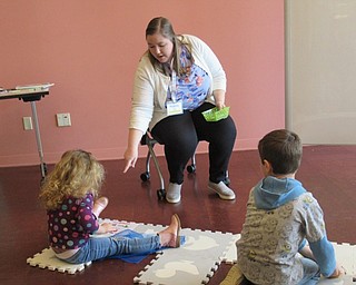 Neighbors | Jessica Harker.Librarian Amelia Dale assisted children in picture bingo at the Michael Kusalaba library's Rainy Day event.