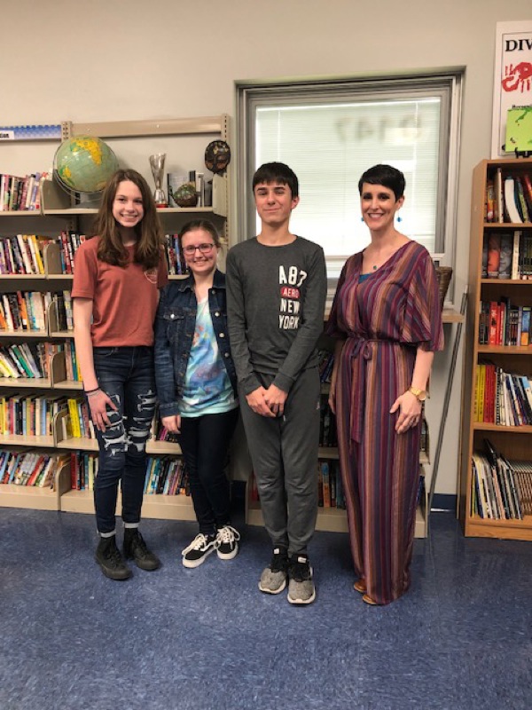 Neighbors | Submitted.Austintown Middle School students Kara Pirone, Aeryonnah Zura and Connor Smith were honored for their writing at the Youngstown Area Jewish Federation’s 26th Annual Community Holocaust Commemoration event, where Austintown Middle School teacher Michelle Best was a speaker, on May 2. Pictured are, from left, Pirone, Zura, Smith and Best.