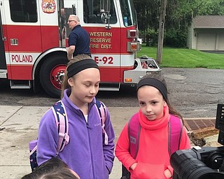 Neighbors | Submitted.Poland student Alexis Flood spoke to local news crews on May 13 after getting a ride to school on a firetruck.
