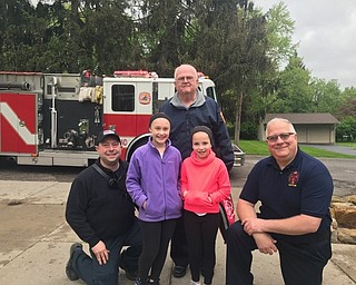 Neighbors | Submitted.Poland fire fighters posed with Alexis Flood, the local winner in the State Fire Marshal Fire Prevention Poster Contest, after giving her a ride to school on their fire engine.