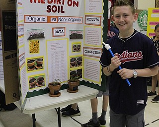 Neighbors | Abby Slanker.A Hilltop Elementary School fourth-grade student conducted a scientific experiment on organic soil versus non-organic soil for the school’s annual Science Fair on May 24.