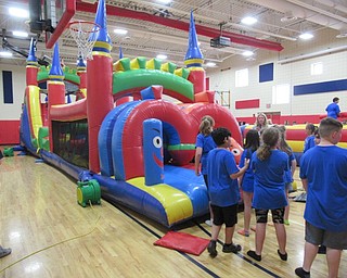 Neighbors | Jessica Harker.Fifth-graders waited to race through the bounce house at Austintown Intermediate School's Fun Day.