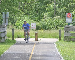 Dave Roberts of Austintown heads back to the Kirk Road Trail Head after hitting the end of the Mill Creek MetroParks bike trail at the Western Reserve Trail Head. The park district has filed suit in court to acquire perpetual easements to lay more than 4 miles of public bike path, part of a larger trail connecting Lake Erie to the Ohio River across four counties.