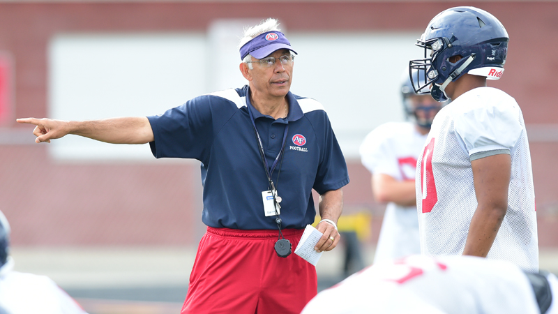 Austintown Fitch coach Phil Annarella gives instructions to Lawrence Harrington during a practice at Fitch High School on Aug. 11, 2015.