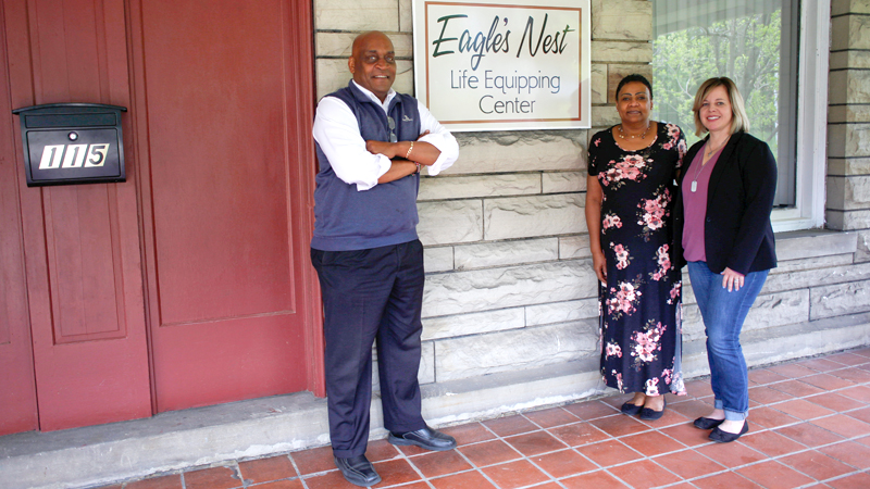 From left, Eagle’s Nest co-founders Rev. Gary Frost and Lynette Frost and executive director Danielle Class stand on the porch of the Eagle’s Nest at 115 Illinois Ave. on Youngstown’s North Side. They expect to start welcoming clients by mid-July.