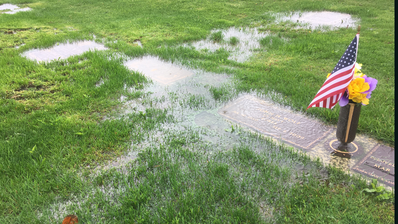 In early May, many flat gravemarkers, including this one for a World War II veteran, at Meadow Brook Memorial Park on State Road in Champion were covered with nearly an inch of water. 
