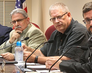 Boardman Township trustees Larry Moliterno, left, Tom Costello, Brad Calhoun and township Administrator Jason Loree listen to residents about flooding issues at the trustees meeting Monday night.