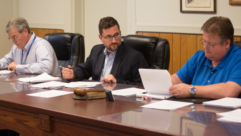 From left, Michael Dockry, Jason Loree and Keith Rogers of the ABC Water and Storm Water District review business during the board's meeting Wednesday at Canfield Township hall. People primarily from Boardman expressed frustration during the meeting over flooding from a May 28 storm.