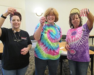 Neighbors | Jessica Harker.Community members showed off their dragon scale necklaces April 23 at the Austintown library.