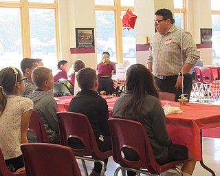 Neighbors | Jessica Harker.Andrew DiPaolo, a meteorologist with WFMJ and St. Charles alumnus, spoke to students about his job on May 6 at the school's Career Day event.