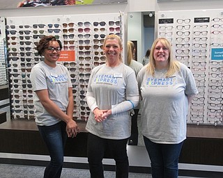 Neighbors | Jessica Harker .Employees of the newly opened Eyemart, Jasmine Howell, Manager Lucy Ehrich and Kelly Shonefelt, worked during the store's grand opening event on May 4.