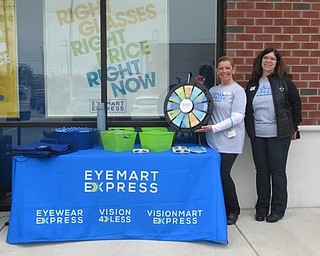 Neighbors | Jessica Harker .Outside the newly opened Eyemart Express store employees offered prizes and opportunities to win gifts to customers who attended the grand opening event.