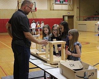 Neighbors | Abby Slanker.Dave Harris, of DPH Architecture, guided Canfield Village Middle School fifth-grade students in building a self-supporting bridge out of blocks and metal plates at the school’s STEM Day on May 20.