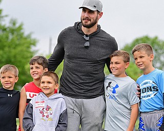 From left, Ty Porter, Nick Hartwig, Carmen Cassease, Hudson Moser and DJ Porter pose for a picture Thursday with New England Patriots linebacker John Simon. The occasion was the Cardinal Mooney annual Football Camp of Champions for kids.