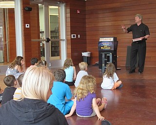 Neighbors | Jessica Harker .Over 30 children and their families gathered at the Michael Kusalaba library June 7 to watch a magic show, which kicked off the library's summer reading program.