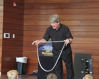 Neighbors | Jessica Harker .The Michael Kusalaba library hosted magician Jeff Wawrzaszek, who did a number of tricks using rope and cards for the children gathered at the event.