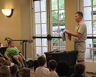 Neighbors | Jessica Harker .Outback Ray's Amazing Animal Show visited the Poland library on June 6, showing off Buddy, the Sudan Plated Lizard, to the community members gathered for the show.