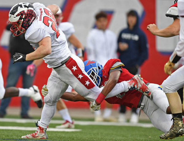 NILES, OHIO - JUNE 13, 2019: Trumbull County's Rob Savin is tackled by Mahoning County's Jordan Trowers in the first half of their game, Thursday night at Niles McKinley High School. Trumbull County won 10-6. DAVID DERMER | THE VINDICATOR