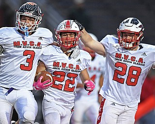 NILES, OHIO - JUNE 13, 2019: Trumbull County's Benton Tennant, center, celebrates with Marco Donatelli, left, and Rob Savin after a interception in the end zone in the second half of their game, Thursday night at Niles McKinley High School. Trumbull County won 10-6. DAVID DERMER | THE VINDICATOR