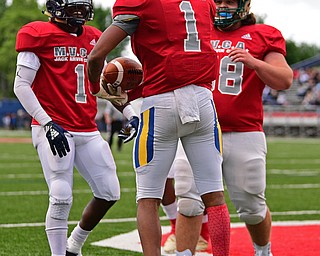 NILES, OHIO - JUNE 13, 2019: Mahoning County's Jordan Trowers, center, celebrates with Ralph Fitzgerald and Lou Delcolle after scoring a touchdown in the first half of their game, Thursday night at Niles McKinley High School. Trumbull County won 10-6. DAVID DERMER | THE VINDICATOR