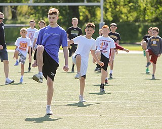 ROBERT K.YOSAY  | THE VINDICATOR..Cardinal Mooney annual Football Camp of Champions for kids 3-8 - about 125 football players attended the two day camp ..students do warm up exercises as Coach Ron Stoops walks among them.