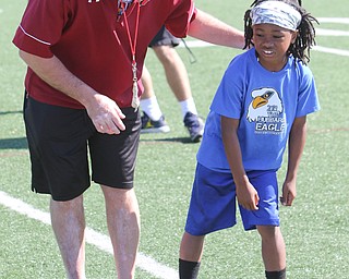  ROBERT K.YOSAY  | THE VINDICATOR..Cardinal Mooney annual Football Camp of Champions for kids 3-8 - about 125 football players attended the two day camp ..Josia Phillips 7  Youngstown learns foot positioning from Mike Tucci - Mooney asst coach