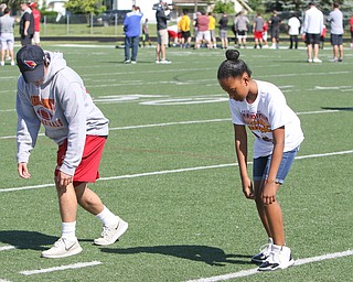  ROBERT K.YOSAY  | THE VINDICATOR..Cardinal Mooney annual Football Camp of Champions for kids 3-8 - about 125 football players attended the two day camp ..Avery Crowder - 11 from North Carolina( visiting here)   watches as Mooney Player Andrew Armile a senior