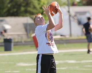  ROBERT K.YOSAY  | THE VINDICATOR..Cardinal Mooney annual Football Camp of Champions for kids 3-8 - about 125 football players attended the two day camp ..fundamentals - as Nathan Hepner 11 of New Springfield tries to reel in a pass