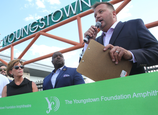 William D. Lewis the vindicator EricRyan, righjt, of JAC Management, speaks as Jan Strasfield of the Youngsotown foundation and mayor Tito Brown look on during ribbon cutting ceremony for  Youngstown foundation Amphitheater 6-14-19.