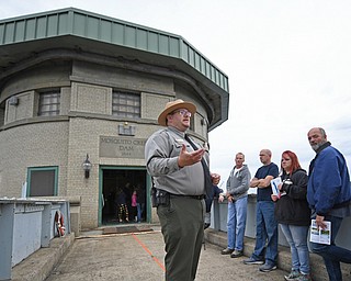 Park ranger Jamison Conley speaks to guests on the bridge leading to the control room of the Mosquito Creek Dam. The occasion was an observance Saturday of Mosquito Lake’s 75th anniversary. The dam was built in a mere 90 days before being finished in April 1944.