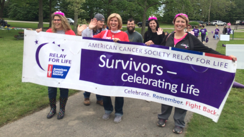 Heather Wright of New Middletown, center, walks among several hundred cancer survivors and supporters at the inaugural Mahoning County Relay for Life in Boardman Park on Saturday. Wright had her initial cancer diagnosis June 24, 2016. Doctors then said she had Stage IV metastatic breast cancer with cancer also spreading to all of her bones.